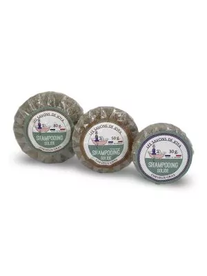 Trois galets de shampooing solide pour cheveux gras de 'Les Savons de Joya', emballés individuellement dans du film plastique. Les étiquettes indiquent les poids de 80g, 50g, et 30g, et mentionnent 'Made in France